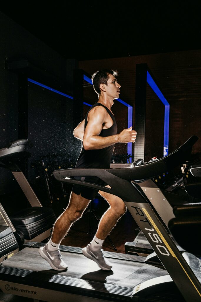 pexels-photo-13896072-13896072 Man exercising on a treadmill indoors, showcasing fitness and determination.